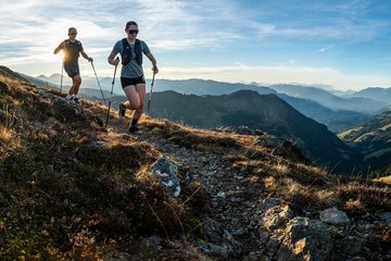 Man and women trailrunning in the mountains